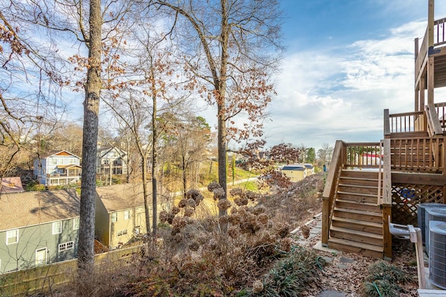 view of yard with a deck and stairway