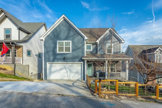 view of front of home with roof with shingles, a porch, an attached garage, fence, and driveway