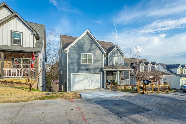 view of front of house featuring driveway, a residential view, roof with shingles, an attached garage, and board and batten siding