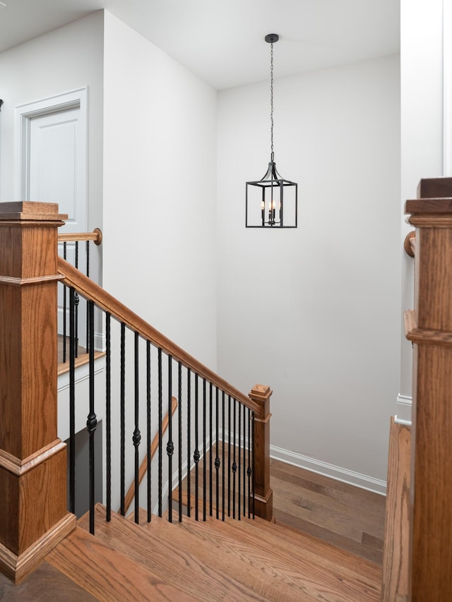 stairs with baseboards and wood finished floors