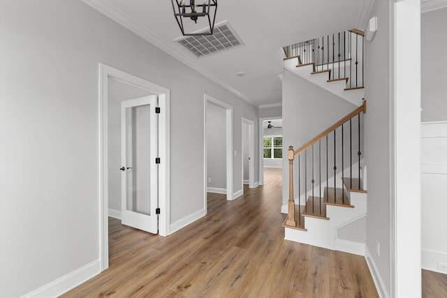 9676 Mayfly Rd # 10, Ooltewah, TN 37363 - entrance foyer featuring wood finished floors, crown molding, and stairway