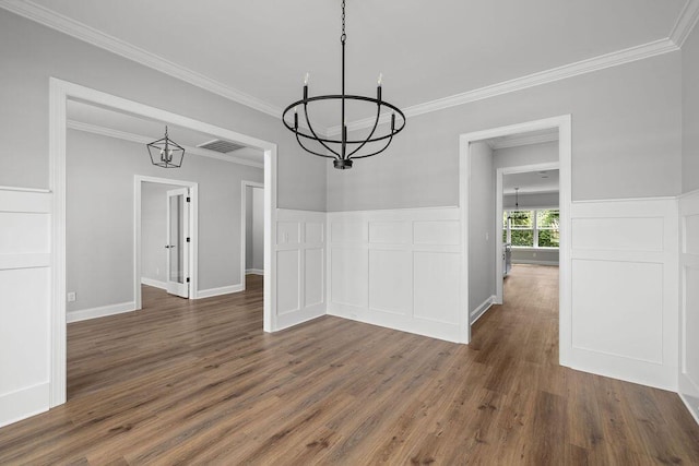 9676 Mayfly Rd # 10, Ooltewah, TN 37363 - unfurnished dining area with a chandelier, wood finished floors, a decorative wall, crown molding, and wainscoting