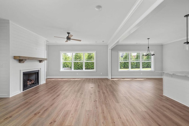 9676 Mayfly Rd # 10, Ooltewah, TN 37363 - unfurnished living room featuring a ceiling fan, light wood-style flooring, healthy amount of natural light, crown molding, and a large fireplace
