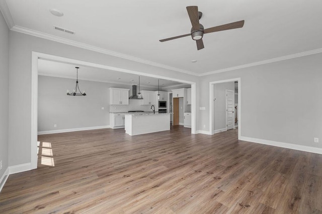 9676 Mayfly Rd # 10, Ooltewah, TN 37363 - unfurnished living room with a ceiling fan, crown molding, wood finished floors, and a chandelier