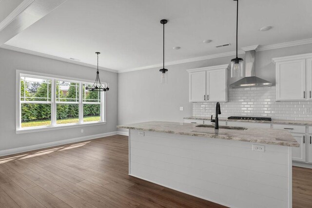 9676 Mayfly Rd # 10, Ooltewah, TN 37363 - kitchen featuring wall chimney exhaust hood, decorative backsplash, white cabinets, light stone countertops, and ornamental molding
