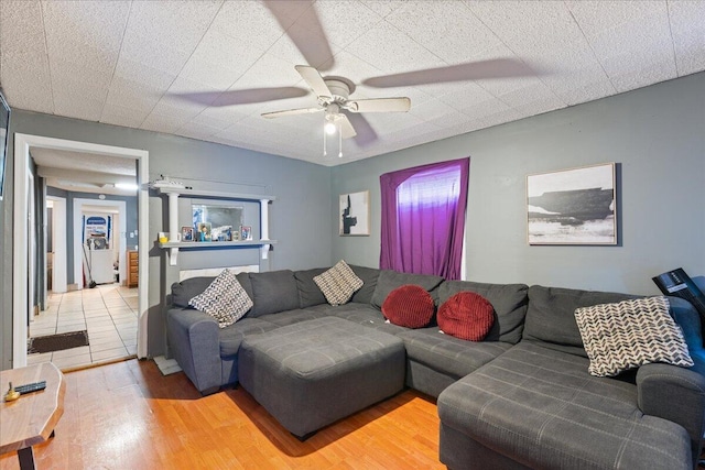 living room featuring ceiling fan and wood finished floors