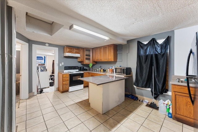 kitchen featuring under cabinet range hood, stainless steel microwave, electric range oven, and light tile patterned floors