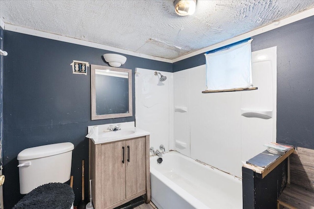 bathroom featuring vanity, toilet, washtub / shower combination, and a textured ceiling