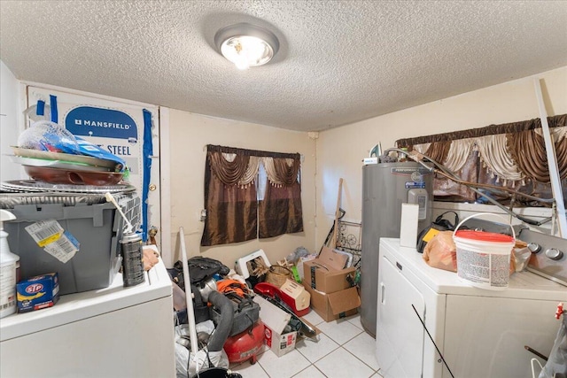 washroom with laundry area, light tile patterned floors, water heater, and washing machine and clothes dryer