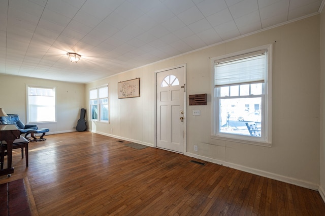 entryway featuring baseboards, visible vents, crown molding, and hardwood / wood-style floors