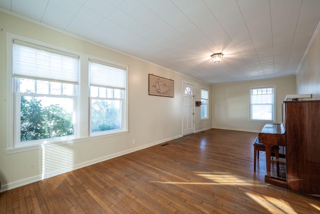 entrance foyer featuring crown molding and hardwood / wood-style flooring