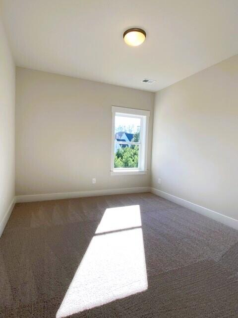 carpeted empty room with baseboards and visible vents