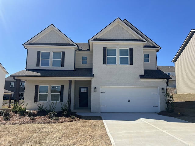 craftsman-style home featuring roof with shingles, driveway, and an attached garage