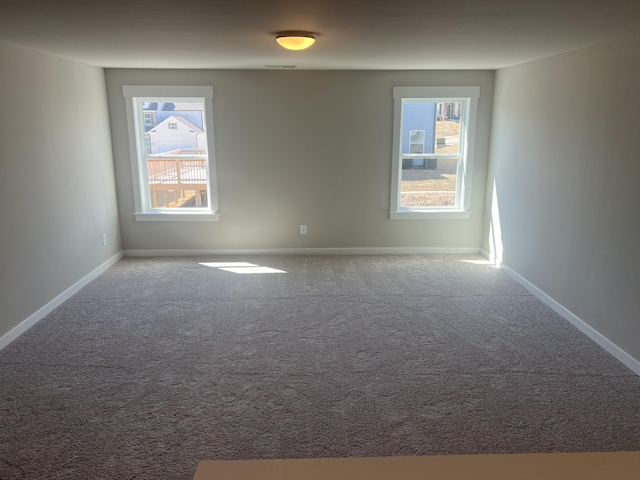 carpeted empty room with visible vents and baseboards