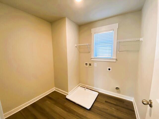 clothes washing area featuring hookup for a washing machine, hookup for an electric dryer, laundry area, dark wood-type flooring, and baseboards