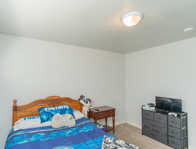 bedroom featuring carpet and baseboards