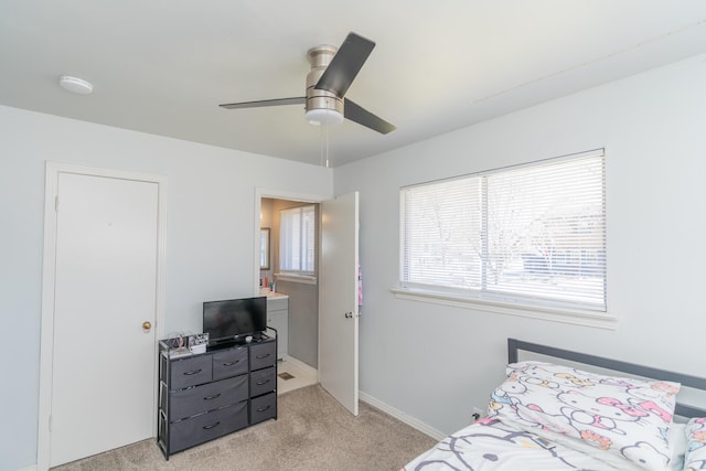 bedroom featuring light colored carpet, ceiling fan, and baseboards