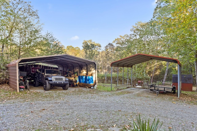 view of car parking with a carport and gravel driveway