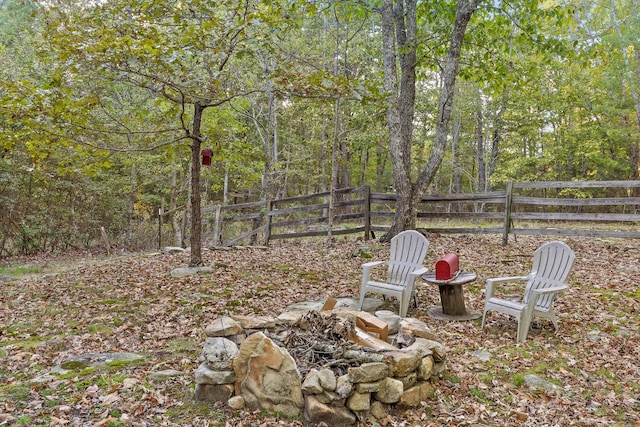 view of yard with fence and a forest view