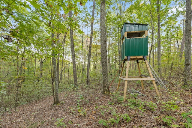 exterior space featuring a wooded view