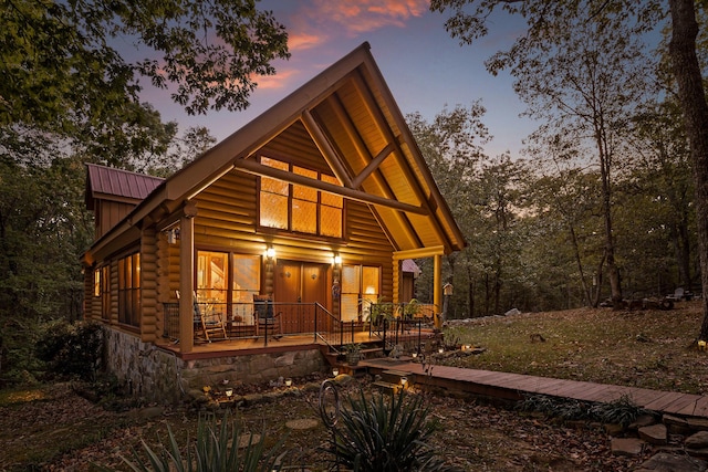 view of front of home with metal roof and log exterior