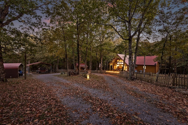 view of street with gravel driveway