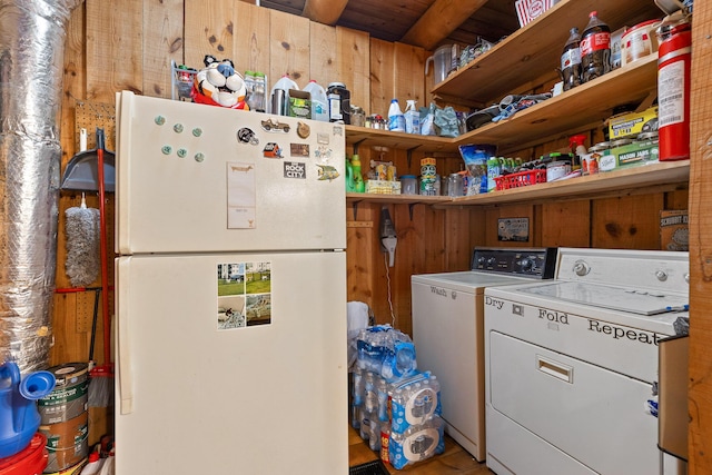 kitchen with washing machine and clothes dryer, open shelves, and freestanding refrigerator