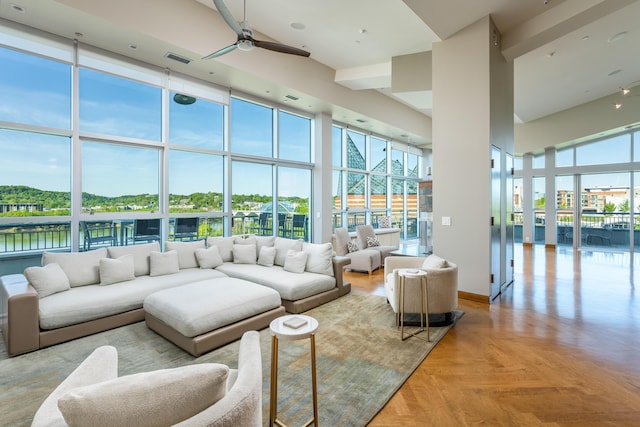 191 Chestnut St Unit 602, Chattanooga, TN 37402 - living room featuring a towering ceiling, a ceiling fan, and floor to ceiling windows