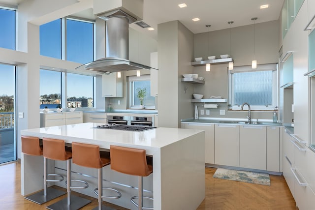 191 Chestnut St Unit 602, Chattanooga, TN 37402 - kitchen with modern cabinets, ventilation hood, a kitchen island, white cabinets, and stainless steel appliances