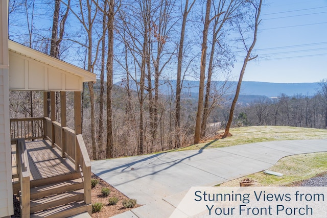 view of patio / terrace with a forest view and a mountain view