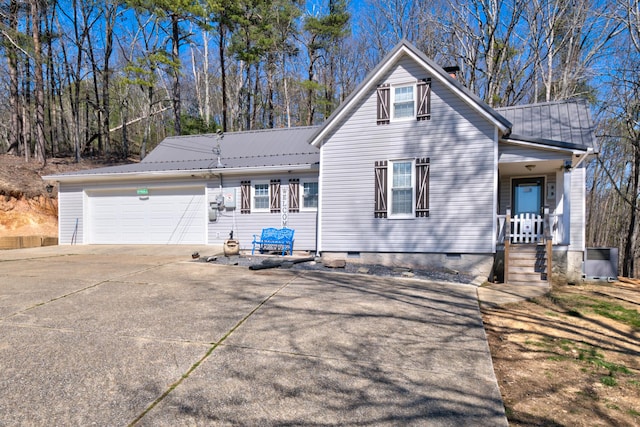 view of front of home featuring driveway, a garage, metal roof, crawl space, and a porch