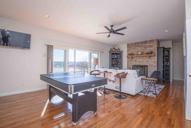 game room with a fireplace, recessed lighting, a ceiling fan, wood finished floors, and baseboards