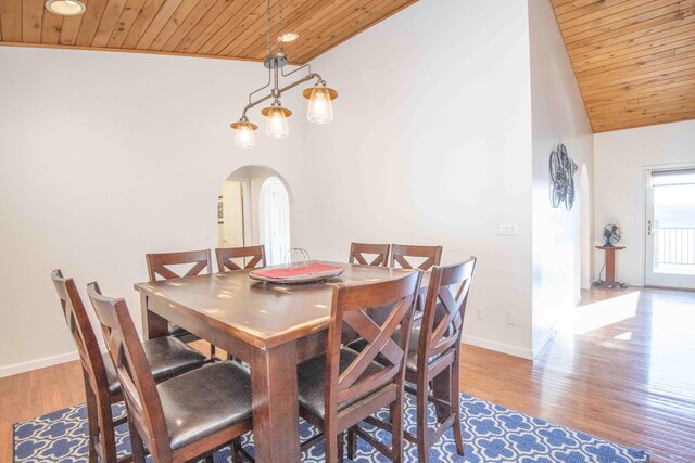 dining room featuring wood ceiling, arched walkways, and wood finished floors