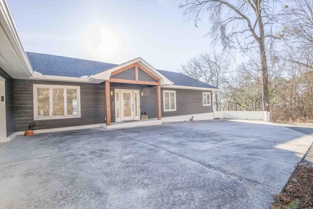 exterior space featuring a shingled roof