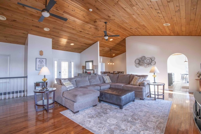 living area with high vaulted ceiling, wooden ceiling, arched walkways, and wood finished floors