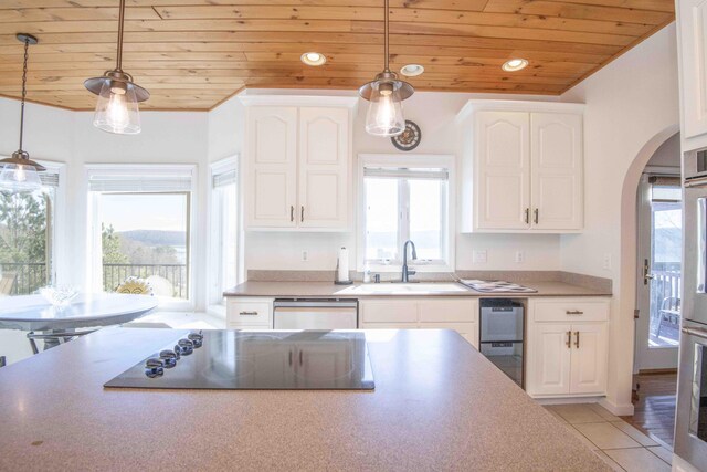 kitchen with arched walkways, wooden ceiling, black electric cooktop, a sink, and dishwasher