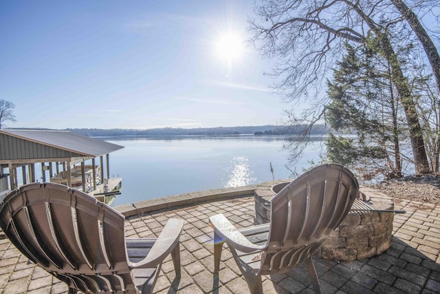 view of patio / terrace with a water view and a boat dock