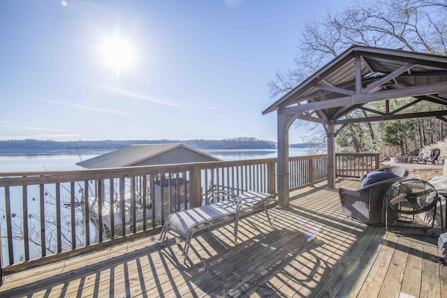 deck with a gazebo and a water view