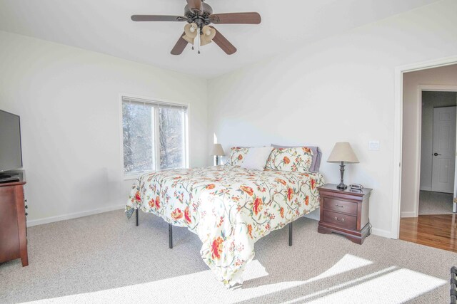 carpeted bedroom featuring ceiling fan and baseboards