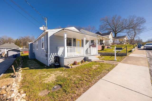 view of property exterior featuring covered porch and a lawn