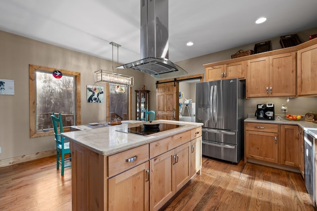 kitchen featuring a center island, island exhaust hood, stainless steel refrigerator with ice dispenser, a barn door, and black electric cooktop