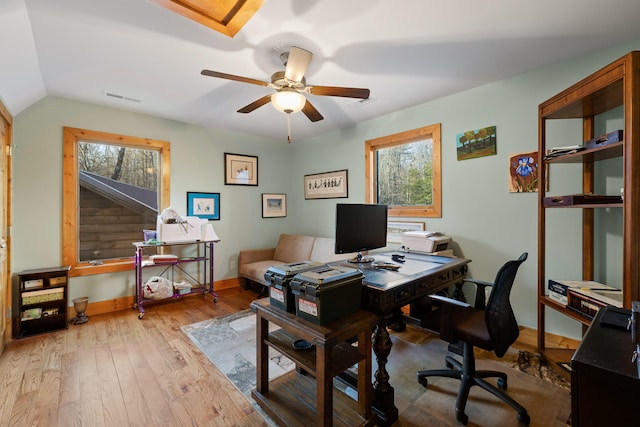 office area with a ceiling fan, wood-type flooring, visible vents, and a healthy amount of sunlight