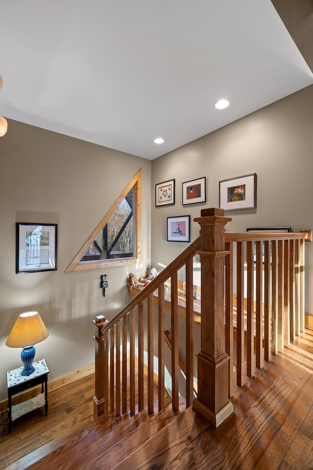 stairs featuring recessed lighting and hardwood / wood-style flooring