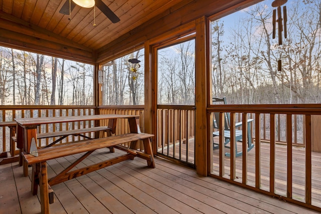 sunroom featuring a ceiling fan, lofted ceiling, and wooden ceiling