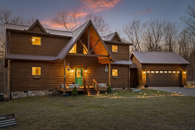 view of front of property featuring metal roof, an attached garage, driveway, a yard, and crawl space