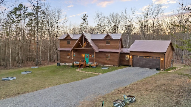 view of front of property with a front yard, crawl space, metal roof, a garage, and driveway