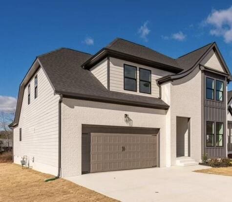 view of front of property featuring driveway and an attached garage