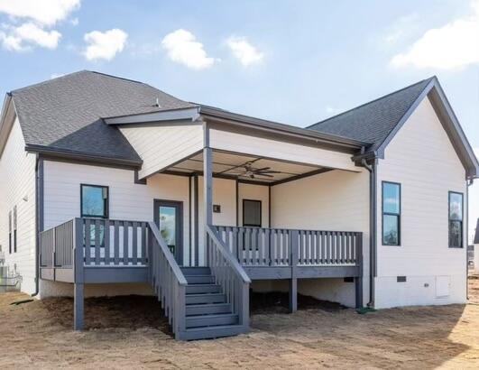 back of property featuring crawl space and a shingled roof