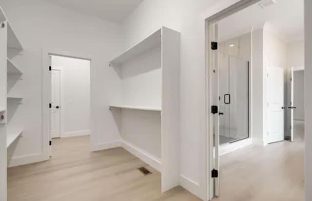 walk in closet featuring visible vents and light wood-style flooring