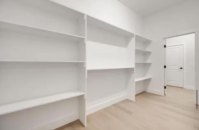 spacious closet featuring wood finished floors